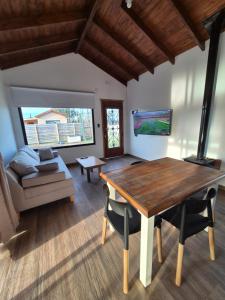 a living room with a wooden table and a couch at Quintasdeconde in San Miguel del Monte
