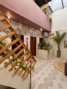 a staircase in a building with plants on the wall at Ammonite Hostel - Itacaré in Itacaré