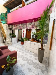 a living room with a couch and plants in a building at Ammonite Hostel - Itacaré in Itacaré +9 photos