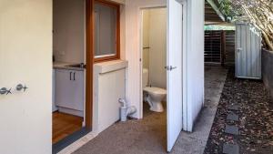 an open door to a bathroom with a toilet at Within Oceans Reach in Cape Woolamai +14 photos