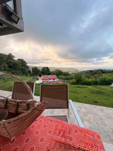 a table and chairs on a patio with a view at Kessydryss in Sainte-Marie