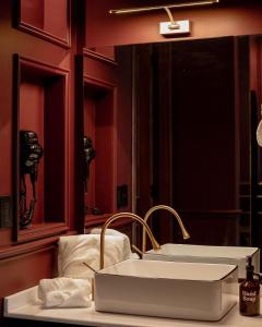 a bathroom with a white sink and a mirror at The Urban Muse suite in Mexico City +35 photos