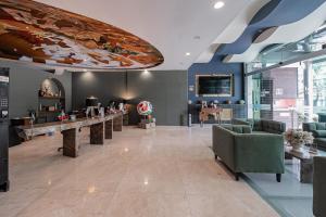 a lobby with a large painting on the ceiling at The Urban Muse suite in Mexico City