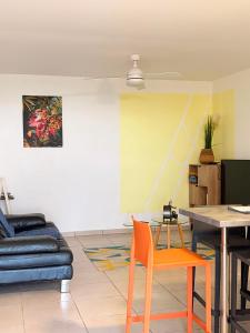 a living room with a table and a couch at Kessydryss in Sainte-Marie