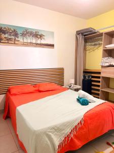 a bedroom with a bed with a red and white blanket at Kessydryss in Sainte-Marie