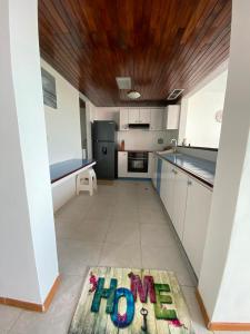 a kitchen with a sign that says home on the floor at puerto real isla de margarita in La Playa