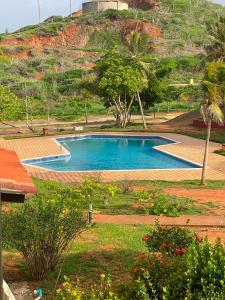 a swimming pool in a yard with a hill at puerto real isla de margarita in La Playa