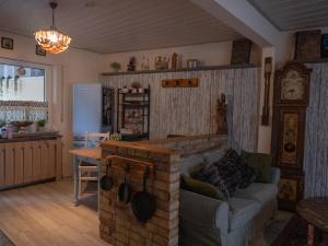 a living room with a couch and a brick fireplace at Finca South Sahara in Bruchsal