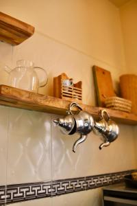 a kitchen faucet on a wall in a kitchen at The FlowHost in Tamraght Ouzdar +193 photos