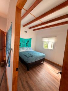 a bedroom with a bed in a room at Cabaña Tea Tea 2 in Hanga Roa