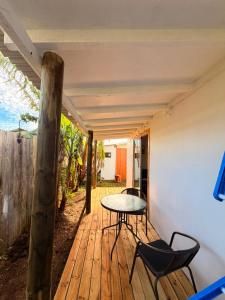 a room with a table and chairs on a wooden deck at Cabaña Tea Tea 2 in Hanga Roa +28 photos