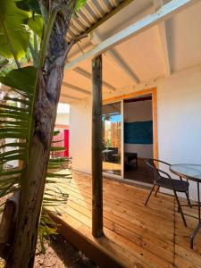 a wooden deck with a table and chairs on a house at Cabaña Tea Tea 2 in Hanga Roa