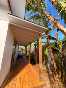 a house on the beach with a wooden deck at Cabaña Tea Tea 2 in Hanga Roa