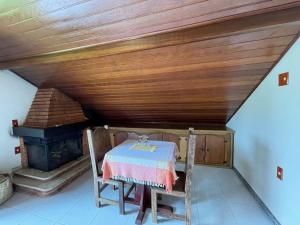 a room with a table and a stove in a attic at Pousada Bela Mauá in Itatiaia