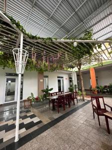 a patio with a basketball hoop and tables and benches at Hotel Song biển in Phan Thiet