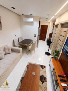a living room with a couch and a table at Portogolf elalamin in El Alamein