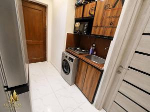 a kitchen with a sink and a washing machine at Portogolf elalamin in El Alamein