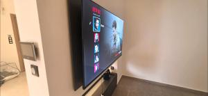 a flat screen tv hanging on a wall at Luxury Apartment in Tlemcen