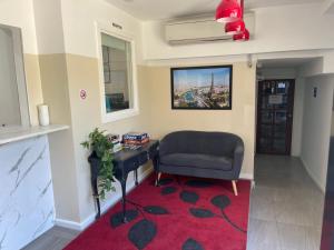 a living room with a chair and a desk at St Kilda Accommodation in Melbourne