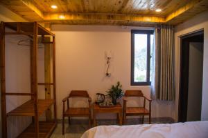 a bedroom with a bunk bed and two chairs and a table at Sapa Station Hotel in Sapa +2 photos