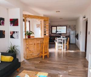 a living room and kitchen with a table and chairs at Cabaña del Mirador 5 in Puerto Pirámides