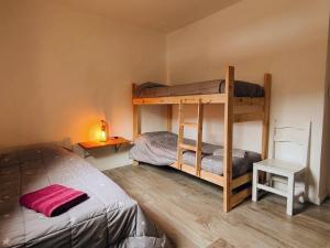 a bedroom with two bunk beds and a bed at Cabaña del Mirador 5 in Puerto Pirámides