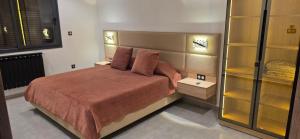a bedroom with a large bed with two pillows at Luxury Apartment in Tlemcen