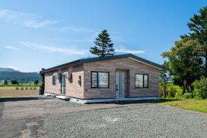 a tiny house sitting on top of a gravel lot at Stellavia in Nakafurano