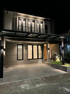 a white building with windows and a balcony at Lioravilla15 Kota Baru Parahyangan in Padalarang