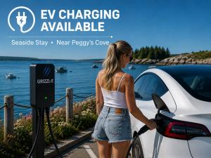 a woman fueling a car at a car charger at 181 Oceanside Inn in Peggy's Cove