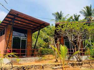 a small house in the middle of a forest at Glass Roof Southern Edge Cabanas in Tangalle