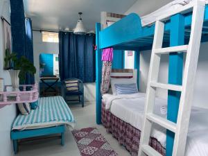 a bedroom with a blue and white bunk bed at The Boathouse in Bang Sare