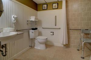 a bathroom with a toilet and a sink at Anchorage Inn & Suites - Portsmouth in Portsmouth +19 photos