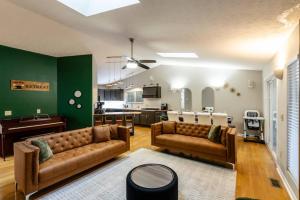 a living room with two couches and a kitchen at Cedar Retreat in McGaheysville