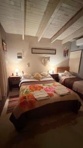 a bedroom with two beds with towels on them at Nogal de Luz in La Rioja