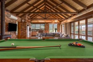 a living room with a pool table and a couch at The Cottage-Gather the crew or the family and prepare for fun times and relaxation. Making memories in Yarra Junction