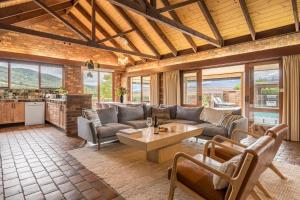 a living room with a couch and a table at The Cottage-Gather the crew or the family and prepare for fun times and relaxation. Making memories in Yarra Junction