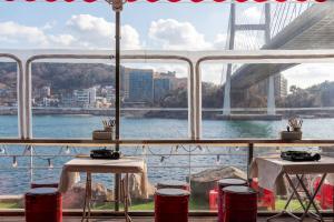 a view of a bridge from a restaurant with two tables at Yeosu Turtleship Pension in Yeosu