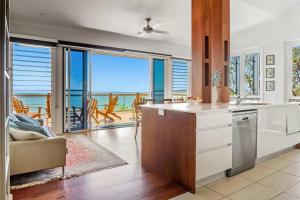 a kitchen with a view of the ocean at Driftwood in Picnic Bay