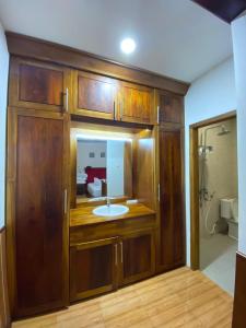 a bathroom with a sink in a wooden cabinet at Villa GHANIA in Labuanbalat +10 photos