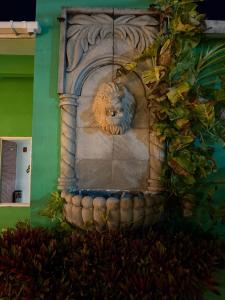 a stone lion statue on the side of a building at Casa Villa Leo in Cancún +10 photos