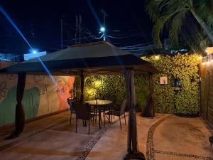 a table and chairs under an umbrella at night at Casa Villa Leo in Cancún