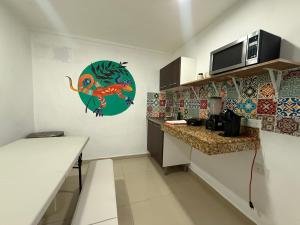 a small kitchen with a counter and a microwave at Casa Villa Leo in Cancún