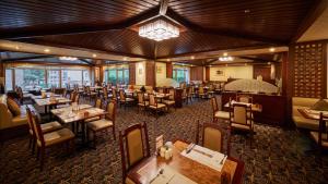 a restaurant with wooden ceilings and tables and chairs at The Howard Plaza Hotel Taipei in Taipei