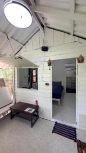 a room with a couch and a table in a room at Nomad house in Hin Kong in Ko Phangan
