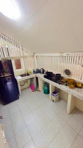 a kitchen with two tables with pots and pans at Nomad house in Hin Kong in Ko Phangan