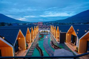 a view of a resort at night with a pool at D'Mount Sky Homestay Syariah in Bukittinggi