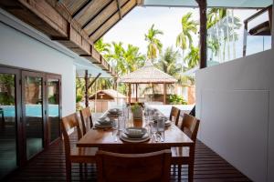 a dining room with a table and chairs at Baan Phuvara Retreat - Romantic Jacuzzi Mountain View Villas in Ao Nang Beach