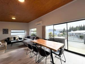 a living room with a table and chairs and a couch at The Bach in Lake Tekapo