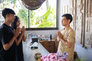 a group of three people clapping in a room at Premadhan Sanctuary in Canggu +48 photos